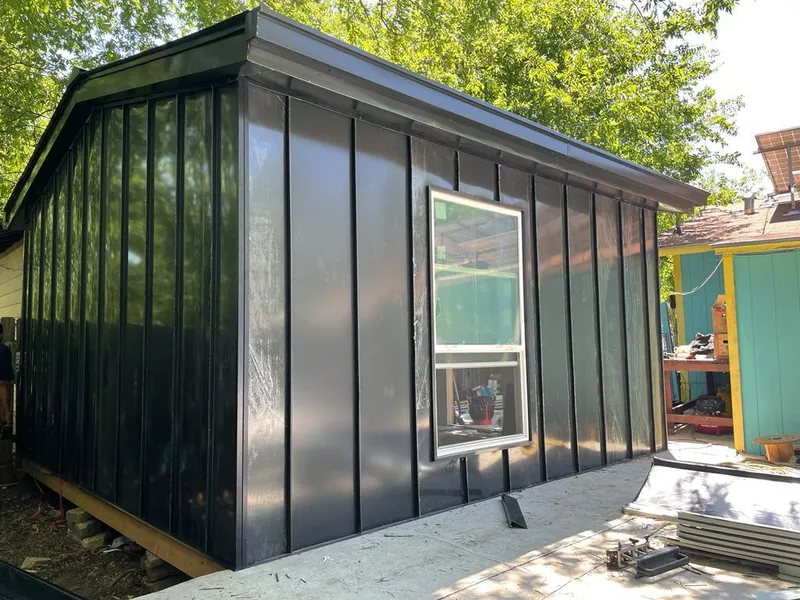 Black standing seam metal wall panels for Roof Inspection in Uhrichsville